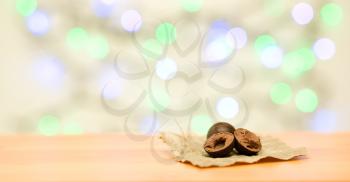 Chocolate sweets on wooden and color lights background