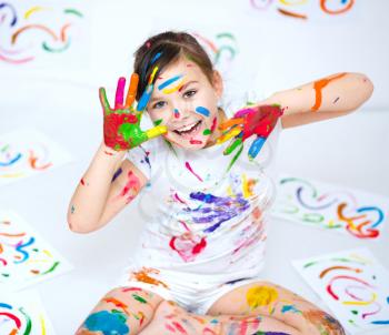 Cute girl showing her hands painted in bright colors