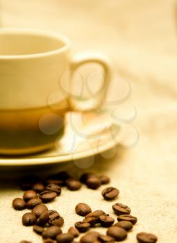 Coffee cup and saucer on canvas background
