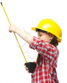 Happy cute girl as a construction worker with tape measure, isolated over white