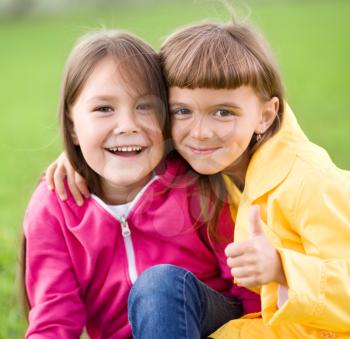 Two cute girls holding face in disbelief