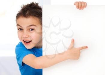 Little boy is holding blank banner