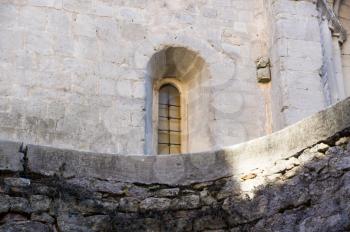details of architecture, historical buildings of Italy. Stone walls and delicate stained glass Window.