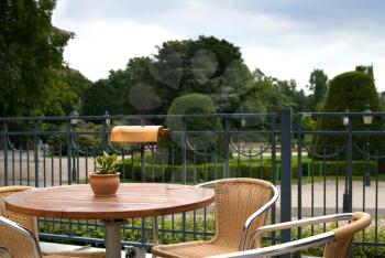 Wicker chairs and table in suburban bar in Park in spring
