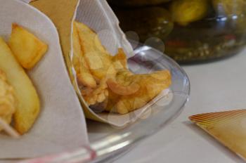 Shrimps, potatoes and vegetables in batter, fried . Street food in cardboard package. Roast, fries fish and vegetables.