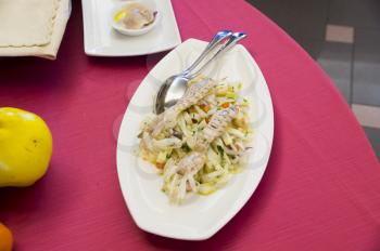 Fish snacks, Mediterranean cuisine on a red tablecloth in an Italian restaurant.