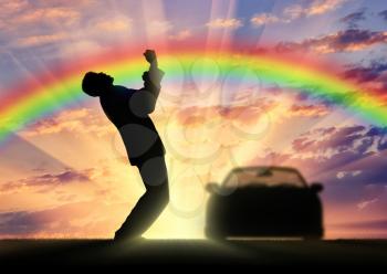 Happiness and success. Happy businessman near the car. Against the background of the rainbow and sunset