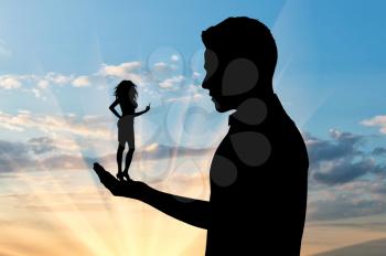 Feminism concept. Silhouette of a small woman showing hand gesture, fuck you, in the hand of a large man