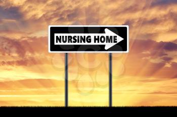 Silhouette pointer road sign nursing home at sunset background