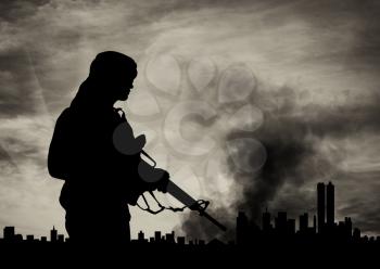concept of terrorism. Silhouette terrorist on city background in smoke