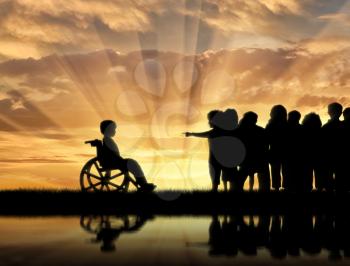 Disabled child in wheelchair and children chased him near sea reflection sunset. Concept disabled child