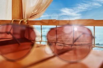 Reflection of the sun in sunglasses against the sea. tourism and recreation concept