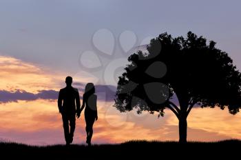 Silhouette of a couple walking at sunset near a tree. The concept of feelings and attitudes