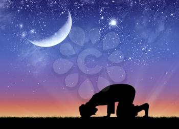 Concept of Islamic culture. Silhouette of man praying at sunset