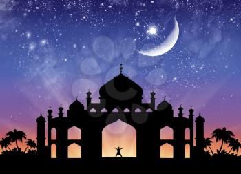 Concept of the Islamic religion. Silhouette of the town hall and happy man on the background of the starry sky and the moon