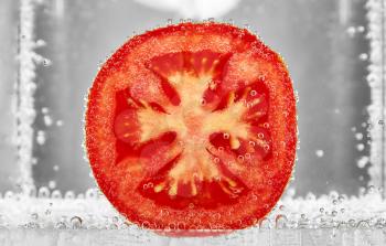 Slice of tomato in the water. design element