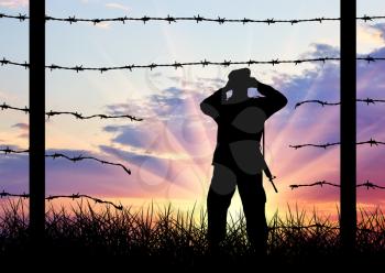 Illegal immigration of refugees. Silhouette of a broken border fence and border guards