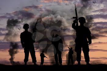 Concept of war. Silhouettes of military soldiers with guns on a background of explosions and smoke
