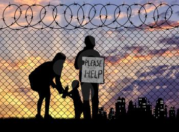 Concept of the refugees. Silhouette of a refugee family with a child near the fence at sunset asking for help