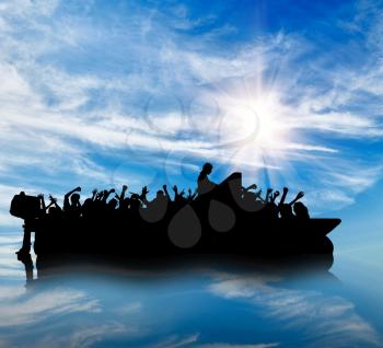 Concept of refugee. Silhouette of a boat floating in a sea of refugees to the border