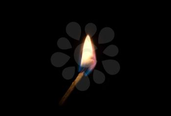 Concept of fire and arson. Burning match on a black background