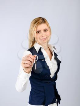 Real estate concept. Smiling business woman holding a key