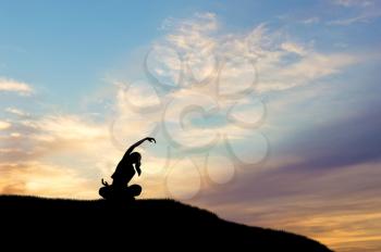 Yoga concept. Silhouette of woman doing yoga at sunset