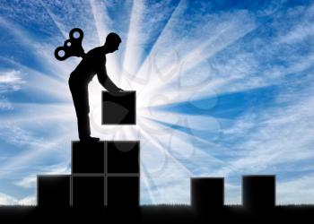 The concept of career growth and motivation. Silhouette of a worker with a clockwork mechanism in the back for a staircase of blocks