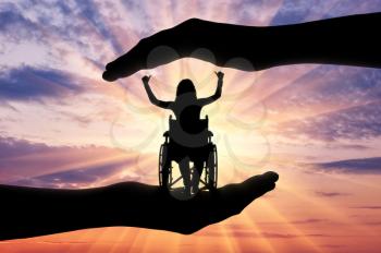 Silhouettes of a happy disabled woman in a wheelchair in the hands of protection and help. The concept of care and help for people with disabilities
