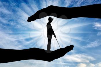 Silhouette of a blind disabled man with a cane in hand of help. The concept of protection and assistance to blind disabled people