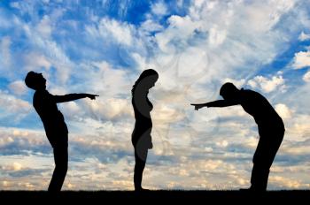 Silhouettes of two men laughing at a woman showing a finger at her. The notion of a frivolous attitude towards a woman