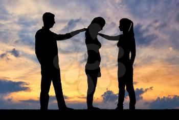 Silhouette of a woman and a man morally support another sad woman. The concept of support and help to people
