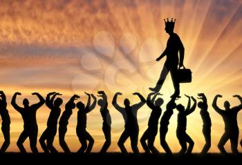 Silhouette of a walking selfish and narcissistic man with a crown on his head on the hands of the crowd. The concept of selfishness and narcissistic personality