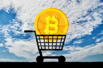 Bitcoin coin lies in the grocery cart. The concept of buying and selling of crypto currency