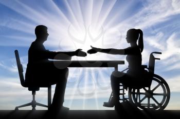 Handshake of a disabled woman in a wheelchair and a man. Disabled worker