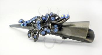 Classical barrette with flowers and blue crystals, is isolated on a white background.