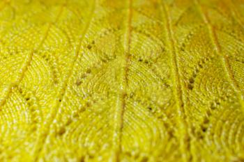 Beautiful yellow background with a knitted pattern.