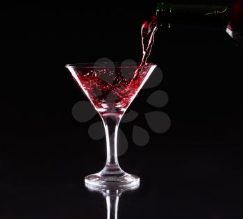 red splashing cocktail on black. 