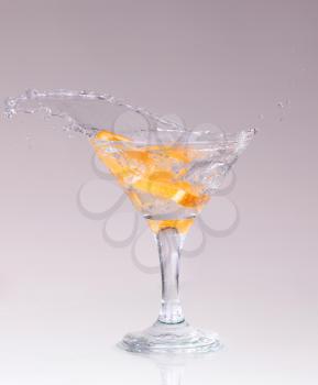 cocktail in a martini glass on a white background with fruit