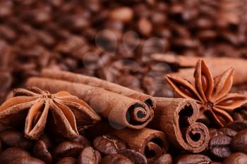 coffee beans, cinnamon, star anise on sacking background.
