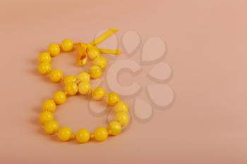Happy woman's day, with yellow bead and bow, eight of march, 8 march on paper
