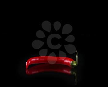 red chili pepper on black background