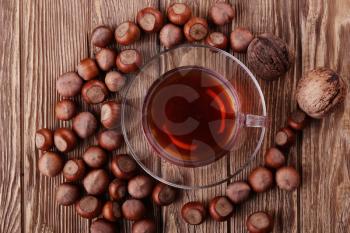 Autumn harvest. nuts on a dark recycled wood background, with copy space .. Top view of tea, nuts