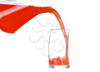 Pouring grapefruit juice into a glass on white background