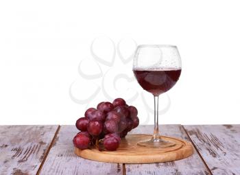 wine pouring into glass with grape and bottles isolated