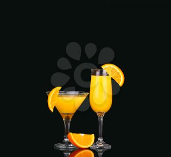 fresh organic orange juice and vodka in a tall glass  on a black background 