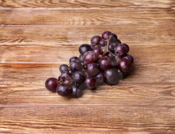 red grapes on wooden table background