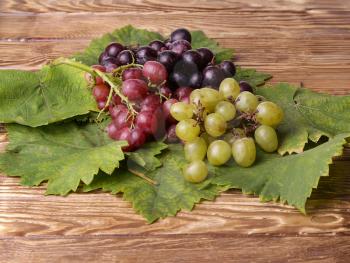 Bunch of grapes on a wooden table.