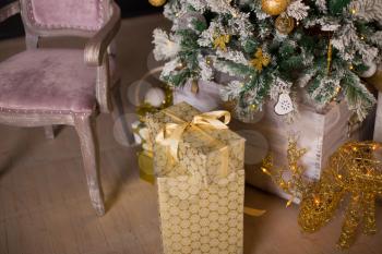 Beautiful holdiay decorated room with Christmas tree with presents under it. Christmas and New Year celebration. Holiday Christmas scene. 