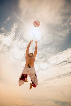 male beach volleyball game player jump on hot sand